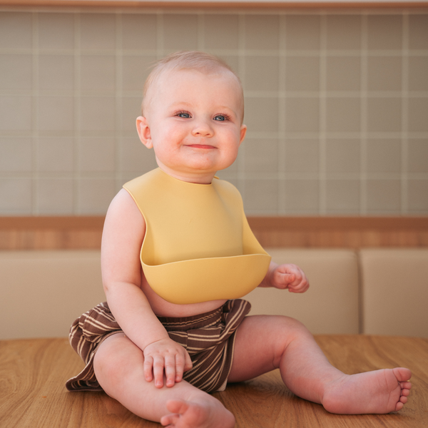 Baby wearing Rommer Pina silicone bib