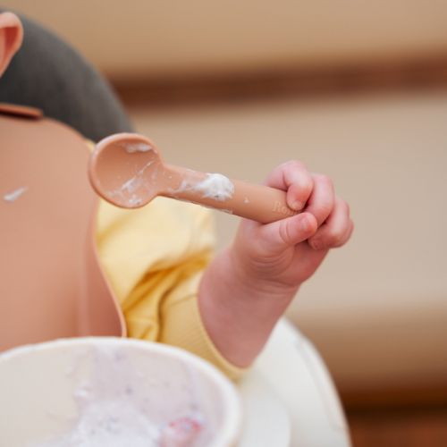 Children's silicon spoon in pastel orange